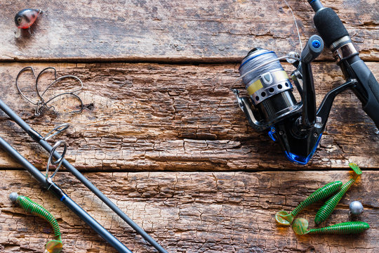 fishing tackle and bait on wooden background