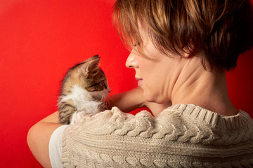 Fototapeta na wymiar Woman playing with a little cat