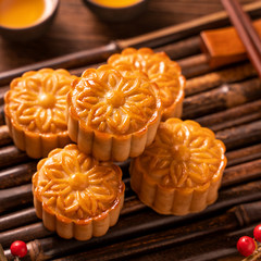 Moon cake Mooncake table setting - Round shaped Chinese traditional pastry with tea cups on wooden...