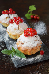 Sweet muffin from gluten free flour and walnut, sprinkled with sugar powder. Homemade baking. Organic healthy vegetarian food. Dairy free pastries. Cupcakes on a dark background. Copy space