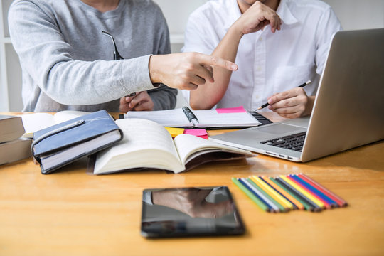 High school tutor or college student group sitting at desk in library studying and reading, doing homework and lesson practice preparing exam to entrance, education, teaching, learning concept