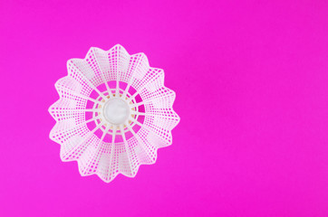 Plastic badminton shuttlecock on a bright pink background. Copy space Amateur accessories for playing badminton. Flat lay, minimalism, top view.