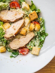 Chicken Salad. Chicken Caesar Salad. Caesar Salad with grilled chicken on plate. Grilled chicken breasts, tomatoes, lettuce, cheese parmesan, croutons