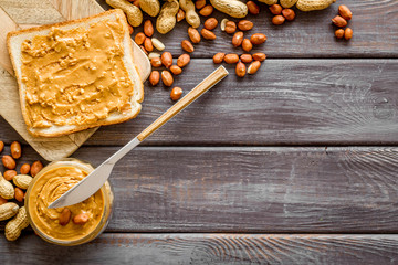peanut butter for cooking breakfast with sandwiches at home on wooden background top view mock-up