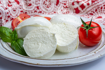 Italian soft cheese mozzarella, white cheese made from cow or buffalo milk with fresh green basil herb and red tomato