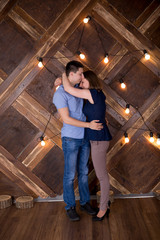 Portrait of Young Couple on Wooden Background