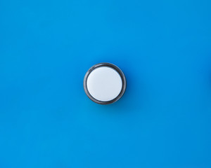 Single plastic white start or machine control power button on panel.