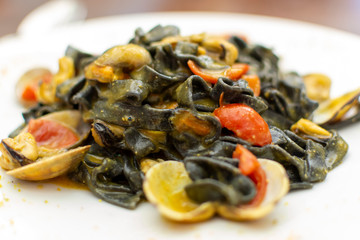 Seafood pasta dish, Italian black fettuccini with vongole clams and mussels