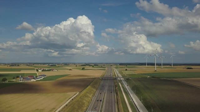 Aerial view of Highway A8 and wind turbines in corn fields on the swabian alp between Ulm and Merklingen with construction works of the Stuttgart21 railway project