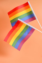 LGBT flag on orange background. Copy space.