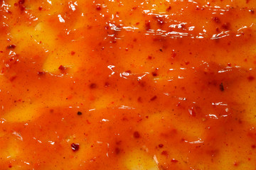 Orange sauce splashes as a background.