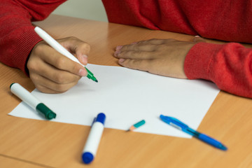 teenager with a felt-tip pen in her fingers prepared for study