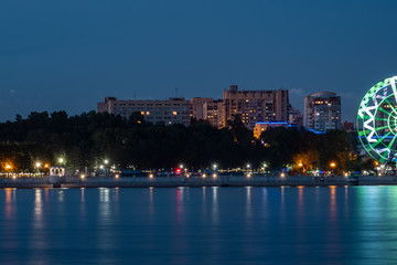 Obraz premium Night View of the city of Khabarovsk from the Amur river. Blue night sky. The night city is brightly lit with lanterns.