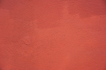 Grunge concrete wall texture painted in red color