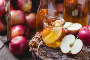 Glass of Apple Juice With Sliced Apples and Cinnamon Stick