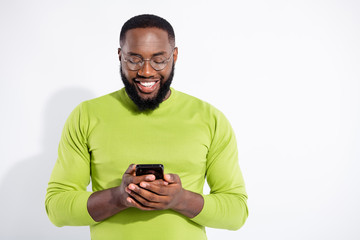 Portrait of concentrated lovely guy holding gadget reading news having eyewear eyeglasses isolated...