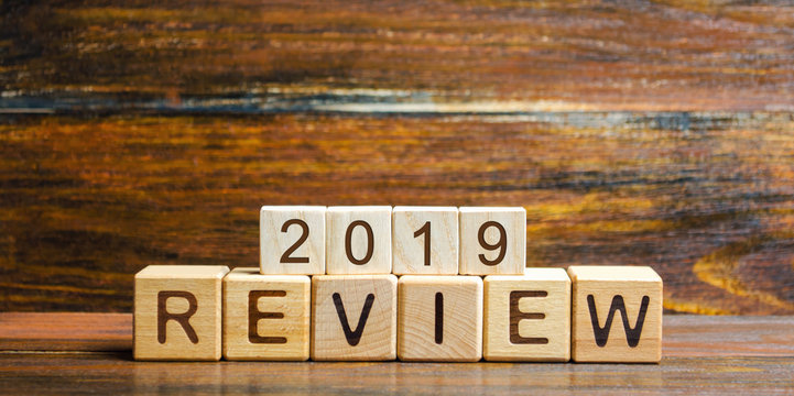 Wooden blocks with the word Review 2019. Business concept. Feedback, Progress. New trends and prospects. Financial performance indicator. Results of the year. Financial and economic activities. Audit.