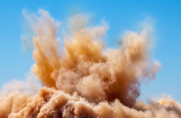 Dust clouds after the detonator blast on the construction site 