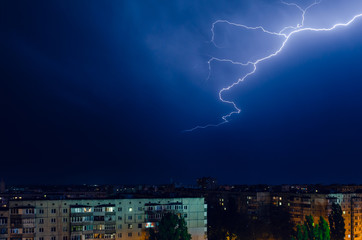 Thunderstorm with lightning and thunder over the night city