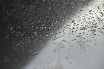 Rain drops and dew. water drops on a gray car roof after stopped raining , selective focus...
