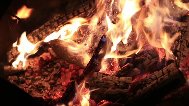 Hot fireplace full of wood and fire burning, closeup