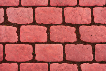 Old cobblestone background with grass. The view from the top