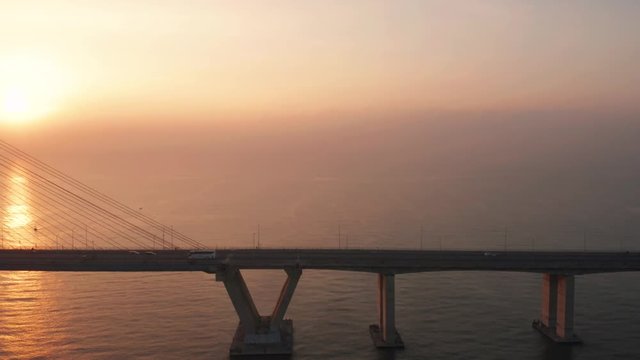 Beautiful aerial landscape of Suramadu bridge on the morning at sunrise time in Surabaya, East Java, Indonesia. Shot in 4k resolution from a drone flying from right to left