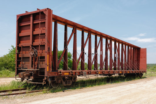 Empty railway freight car on side track.