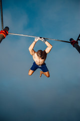 fitness, sport, training, calisthenics and lifestyle concept - young man practicing calisthenics...