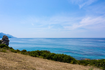 Fototapeta na wymiar Aerial view of beautiful green and rocky island in the blue ocean.