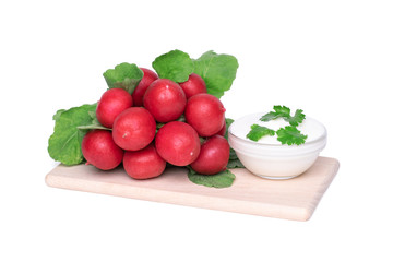 Bunch of garden radish on and sour cream decorated with parsley