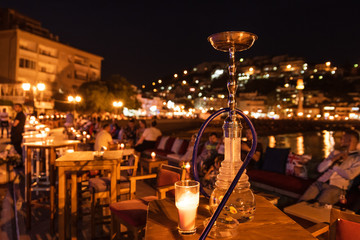 shisha on the table in restaurant, in the background city Ulcinj in Montenegro at night.