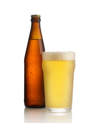 glass of beer and bottle on white background