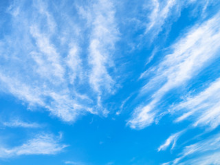 blue sky with ray shaped spindrift clouds