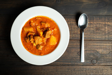 Goulash soup on wooden background.