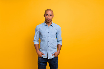 Portrait of nice guy hands pockets look isolated over yellow background