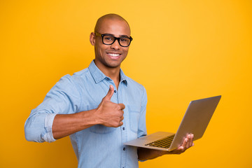 Photo of dark skin guy searching website notebook hold thumb raised up wear specs jeans denim shirt...