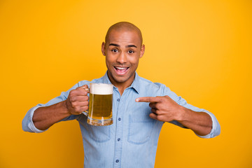 Photo of dark skin amazed guy hold hands beer glass indicate finger cool quality wear jeans denim...