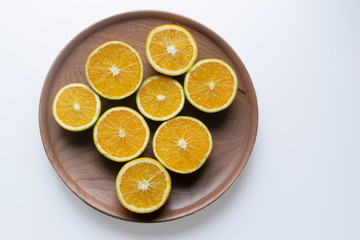 oranges in halves in a wood plate