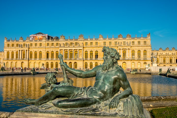 Fototapeta na wymiar Statue and Palace of Versailles on the background, Versailles, France