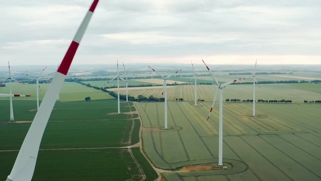 Close-up atrial view of the Wind Turbine Group used to produce electricity against the background of the central European agricultural landscape of Germany