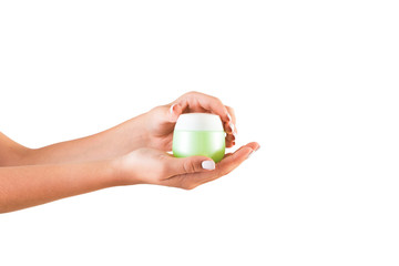 Female hand holding cream bottle of lotion isolated. Girl opening jar cosmetic products on white background