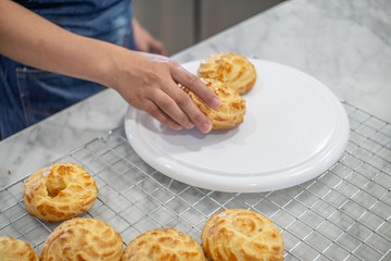 Women hand holding Choux Cream put on a display.
