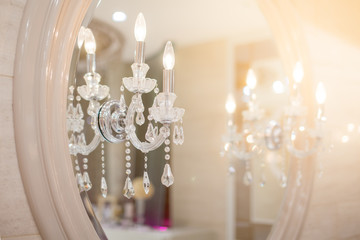 Crystal lamp, mirror front, dressing table in dressing room and makeup