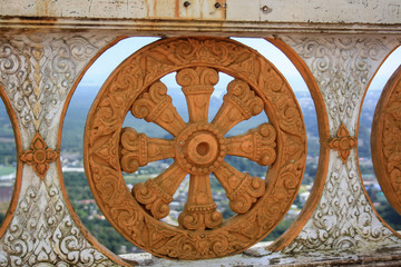 Fototapeta na wymiar Stone wheel flower in patterns in orange color. In the background is a landscape view of a high mountain.