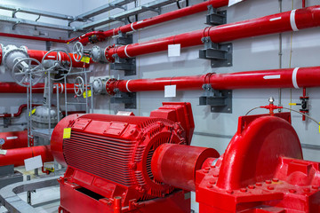Industrial fire pump station. Reliable and trouble-free equipment. Automatic fire extinguishing system control system. Powerful electric water pump, valves, and pipelines for water sprinkler. - obrazy, fototapety, plakaty