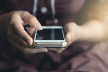 hipster woman using hands touching and typing on mobile phone screen search internet online working or social communication with digital technology app device in coffee shop indoor vintage lifestyle.