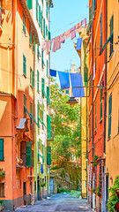 Fototapeta na wymiar Italian street with drying laundry on sunny summer day