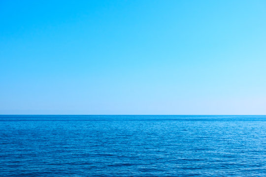 Seascape with sea horizon and clear blue sky