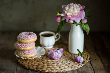 Donuts with fragrant tea. Bakery products. Peonies